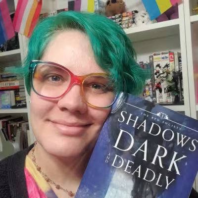 Author holding book and smiling
