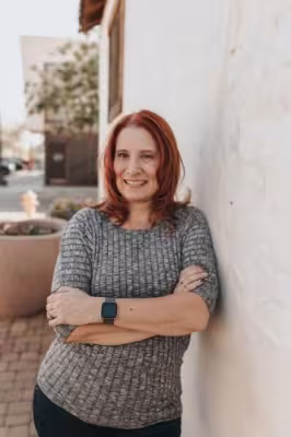 photo of author leaning against wall with arms crossed